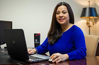 adult student in front of computer